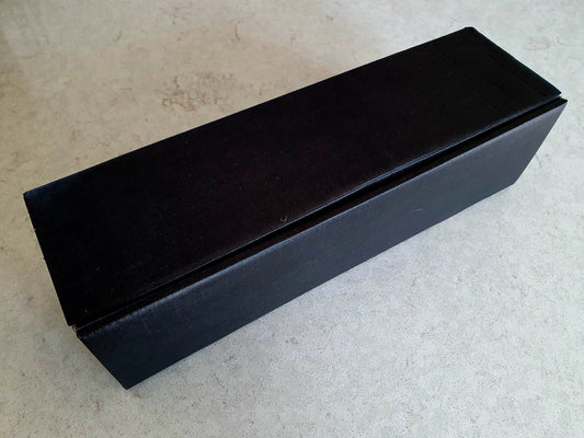 Black storage box for single Christmas cracker.